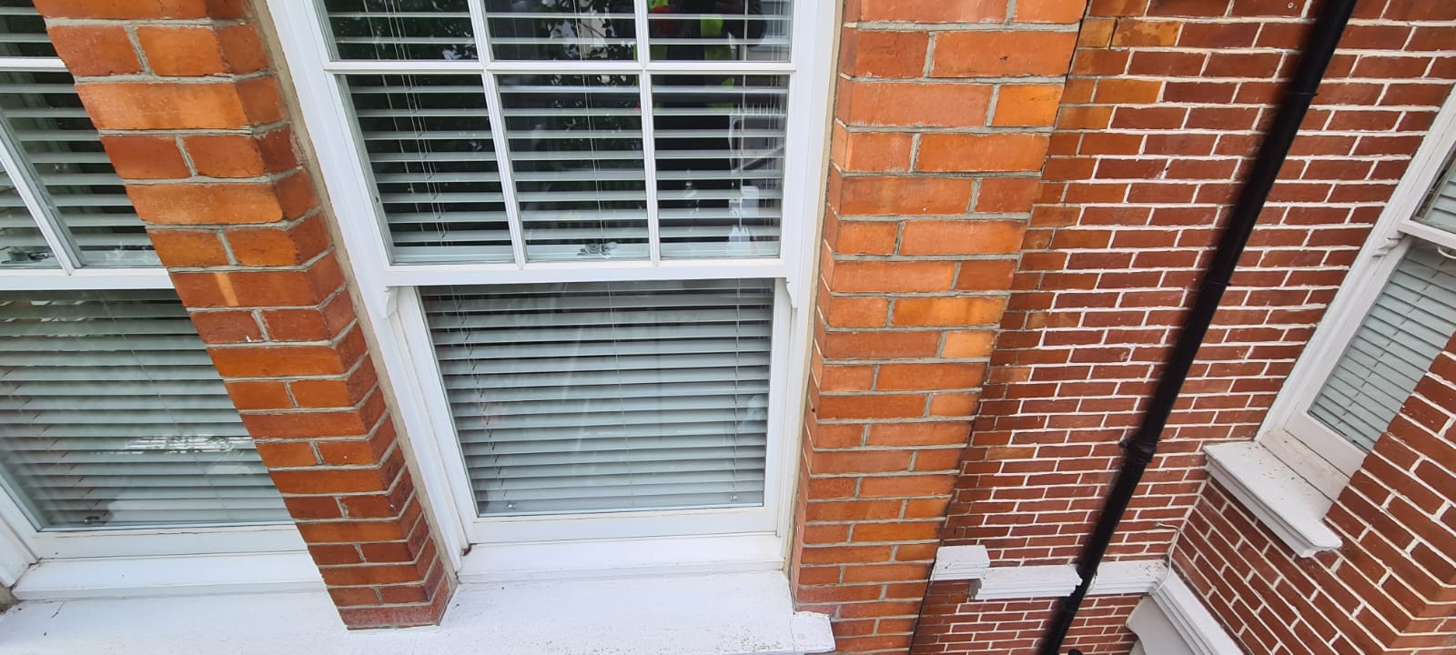 Cleaned Brick wall surrounding a window.