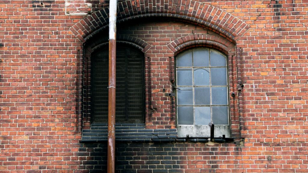 An external brick wall with soot stains.