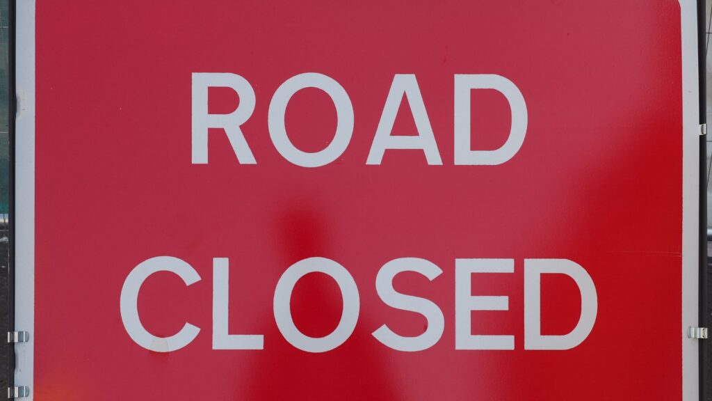A read 'road closed' sign to help illustrate the dangers of diesel spillages on the road.