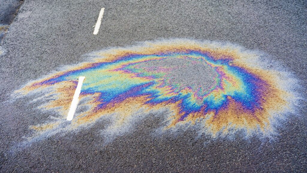An oil spill on a road to illustrate how best to clean a hydraulic oil spill.