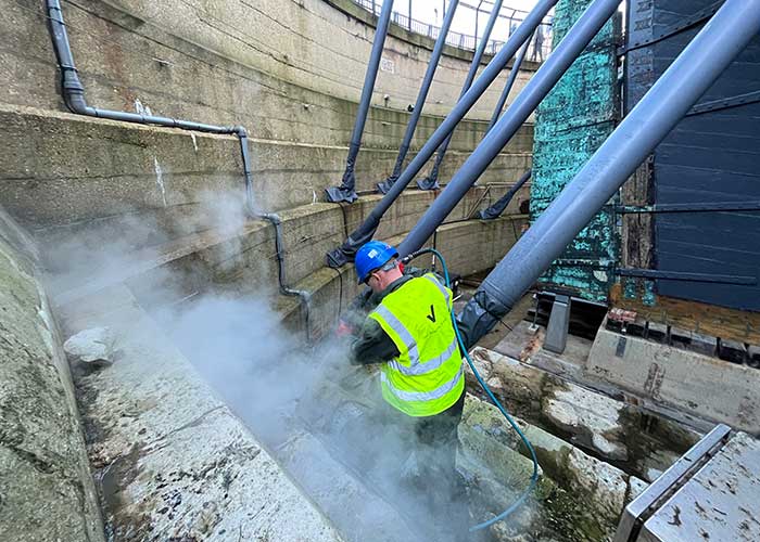 Vinci technicians working to clean the HMS Victory Dry dock, Portsmouth Historic Dockyard.