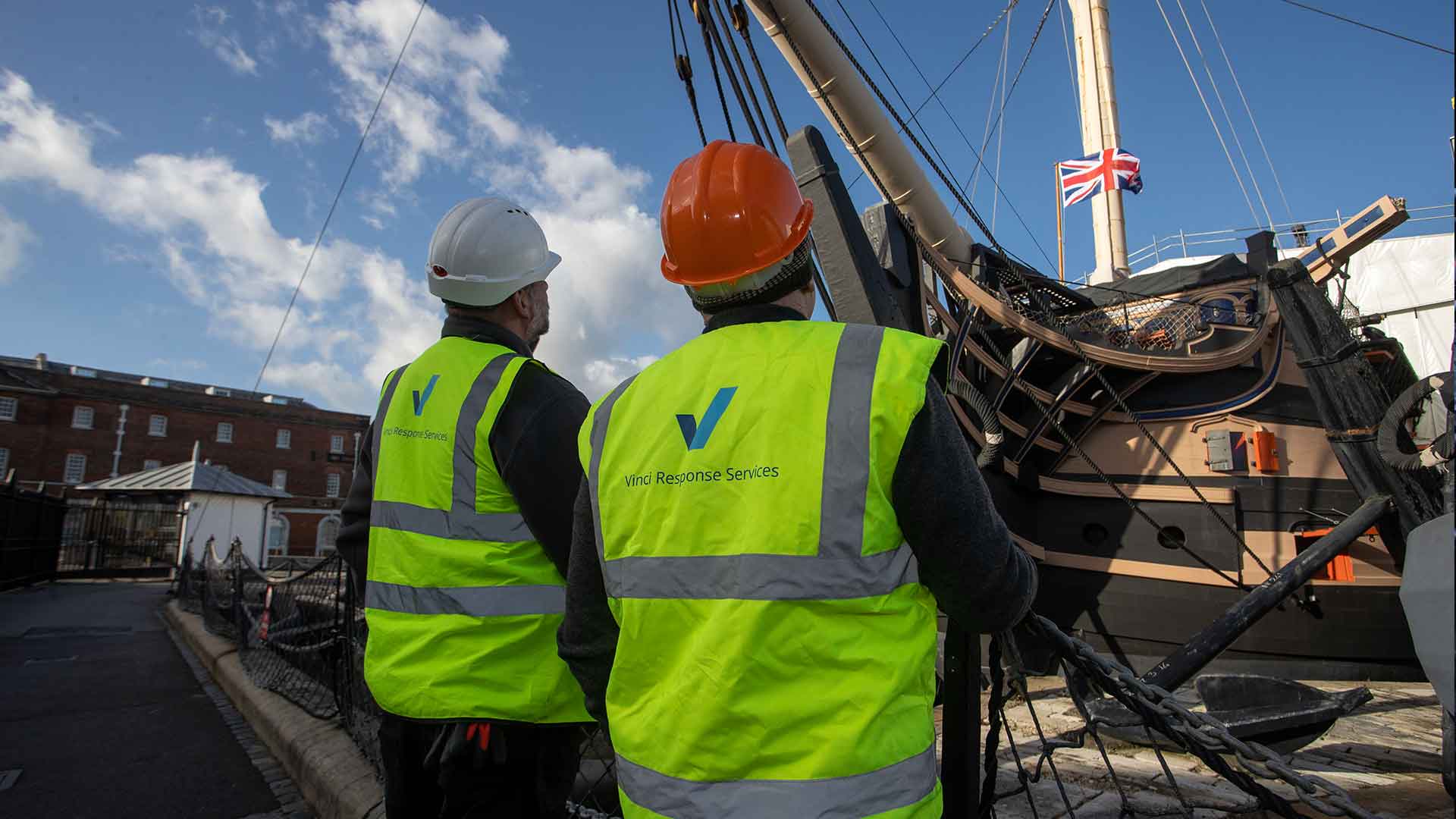 Vinci technicians working to clean the HMS Victory dry dock, at Portsmouth Historic Dockyard.