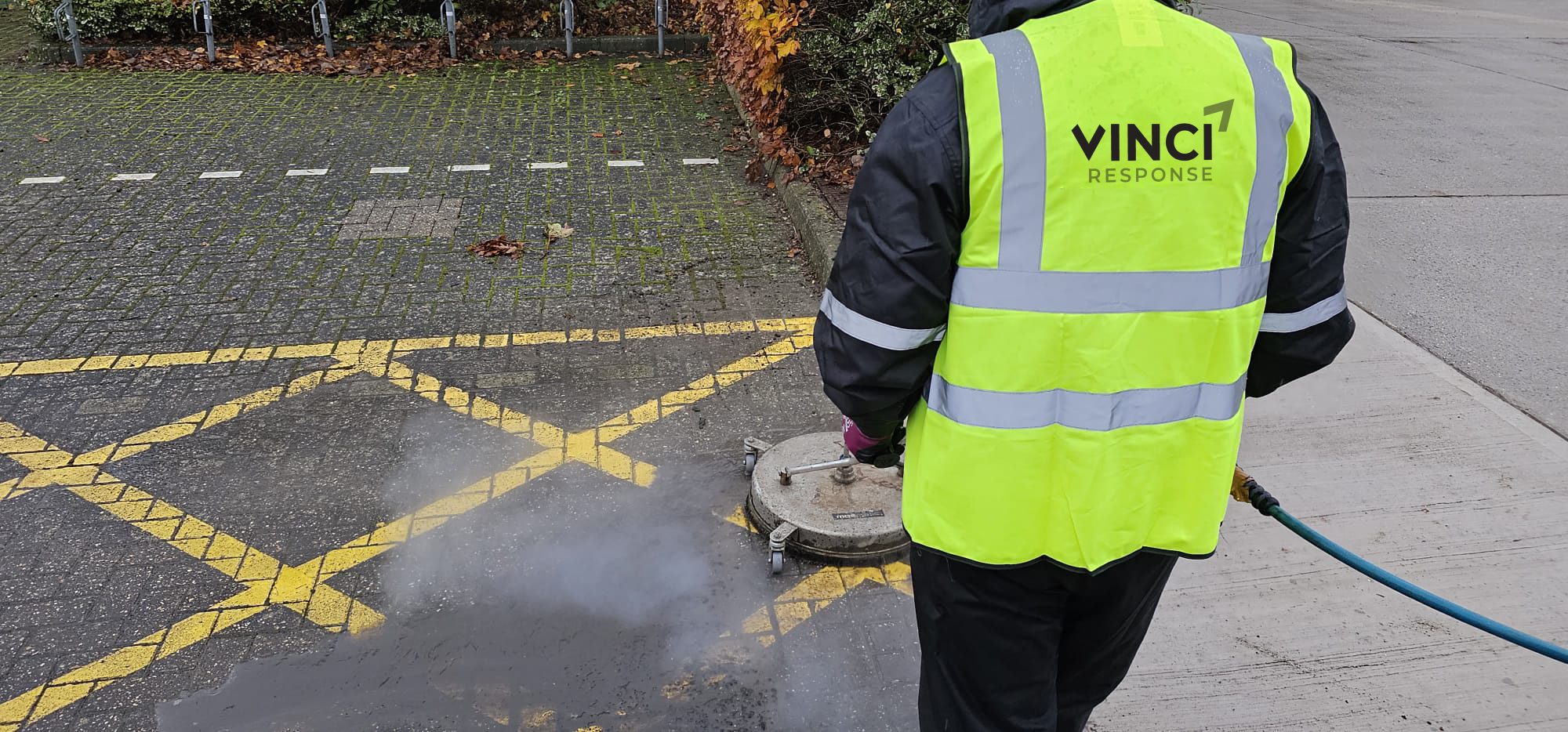A Vinci Response technician cleans a brick floor.